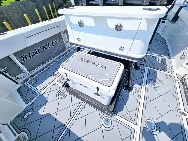 Slide: The Image of 2021 Blackfin 252 CC boat interior with branded cooler and storage. - 13