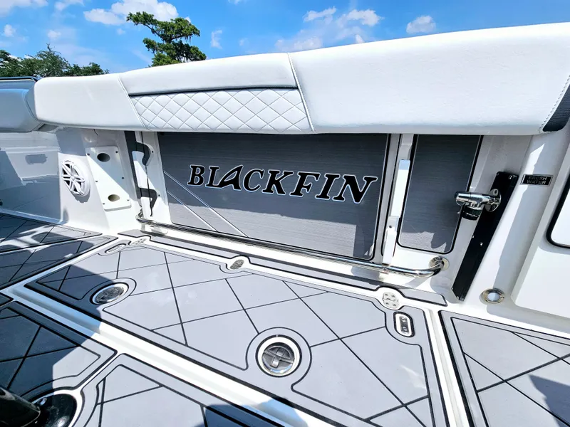 Slide: The Image of 2021 Blackfin 252 CC boat interior with logo, featuring sleek design and modern flooring. - 16