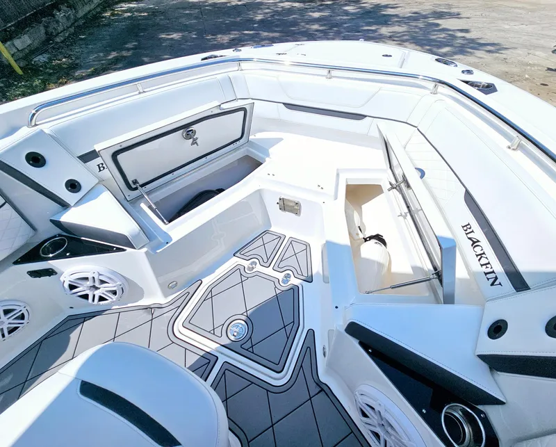 Slide: The Image of 2021 Blackfin 252 CC boat interior with open storage compartments and sleek design. - 20