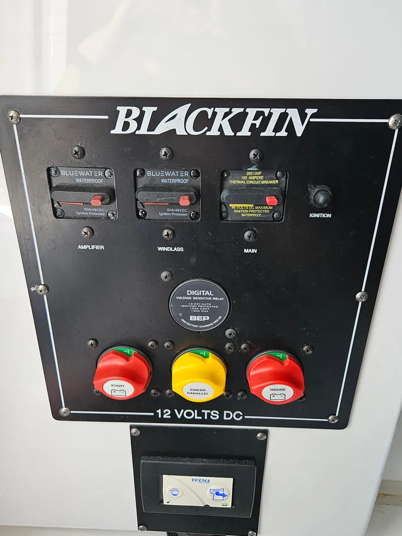 Slide: The Image of Blackfin 252 CC 2021 control panel with switches and indicators for 12 volts DC system. - 21