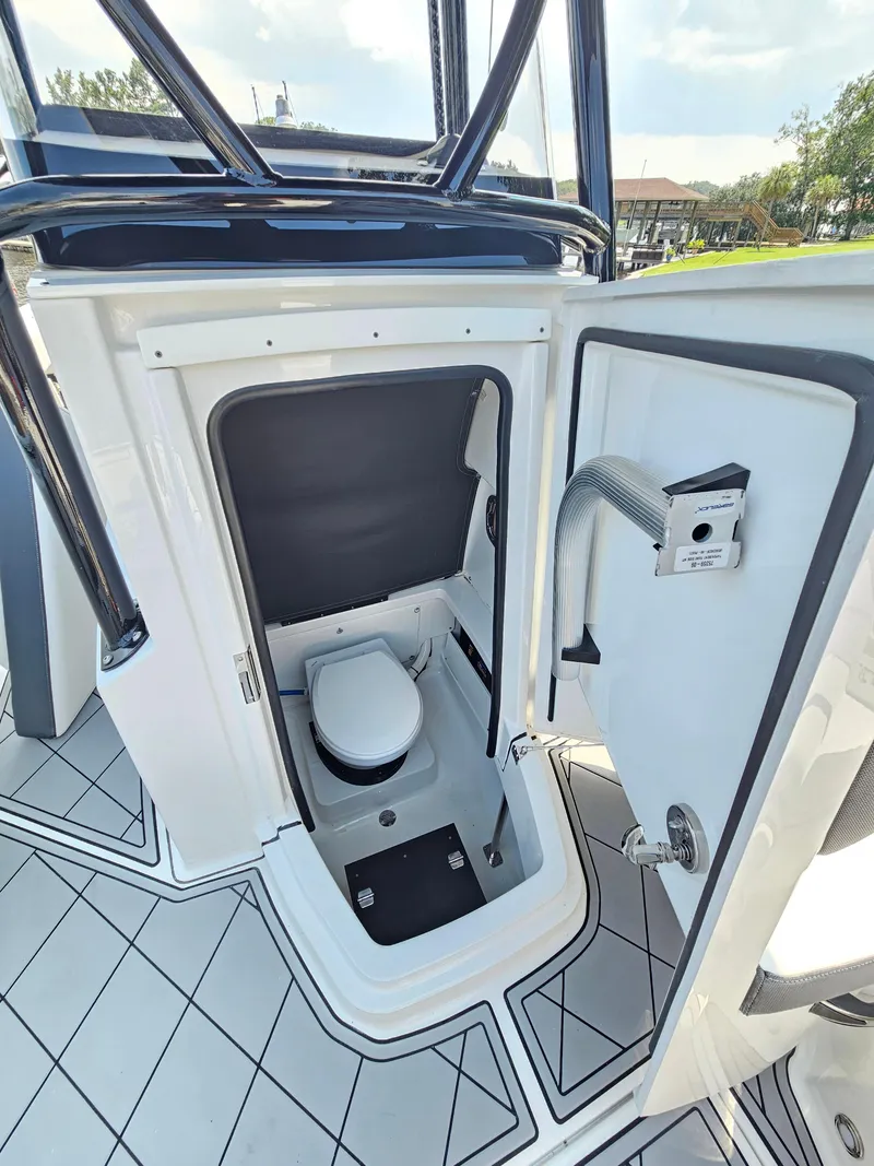 Slide: The Image of 2021 Blackfin 252 CC boat interior with compact marine toilet and sleek design. - 22