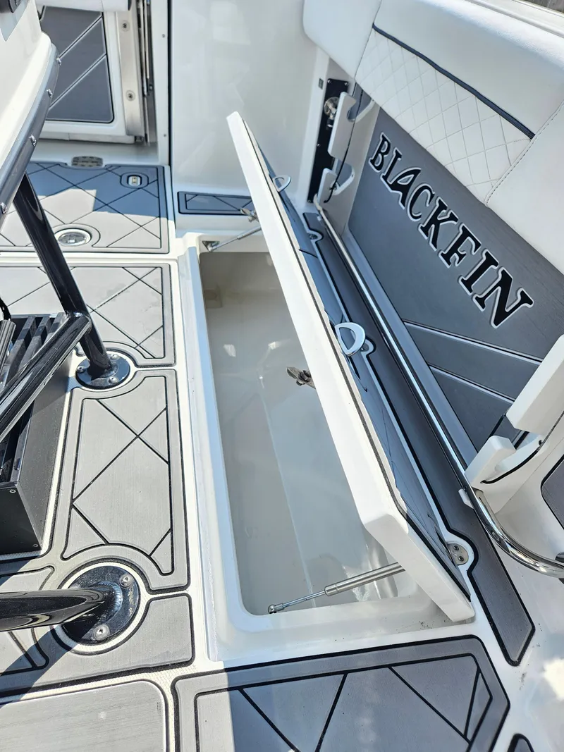 Slide: The Image of 2021 Blackfin 252 CC boat interior with open storage compartment and sleek design. - 28