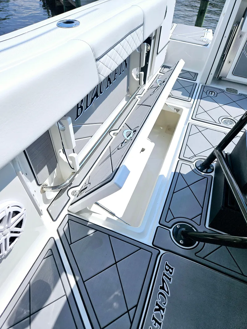 Slide: The Image of 2021 Blackfin 252 CC boat interior with open storage compartment and sleek design. - 30