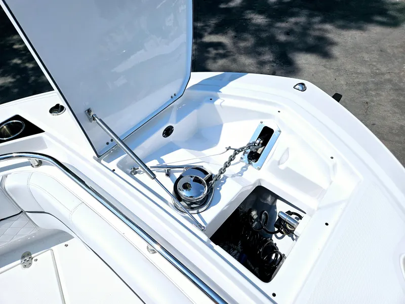 Slide: The Image of Open anchor storage on 2021 Blackfin 252 CC boat, showcasing chain and winch system. - 32