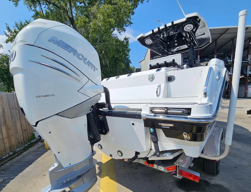 Slide: The Image of 2021 Blackfin 252 CC boat with Mercury outboard engine, parked outdoors. - 5