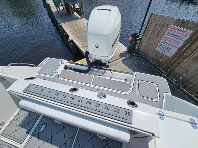 Slide: The Image of 2021 Blackfin 252 CC boat with outboard motor and measuring ruler on deck. - 6