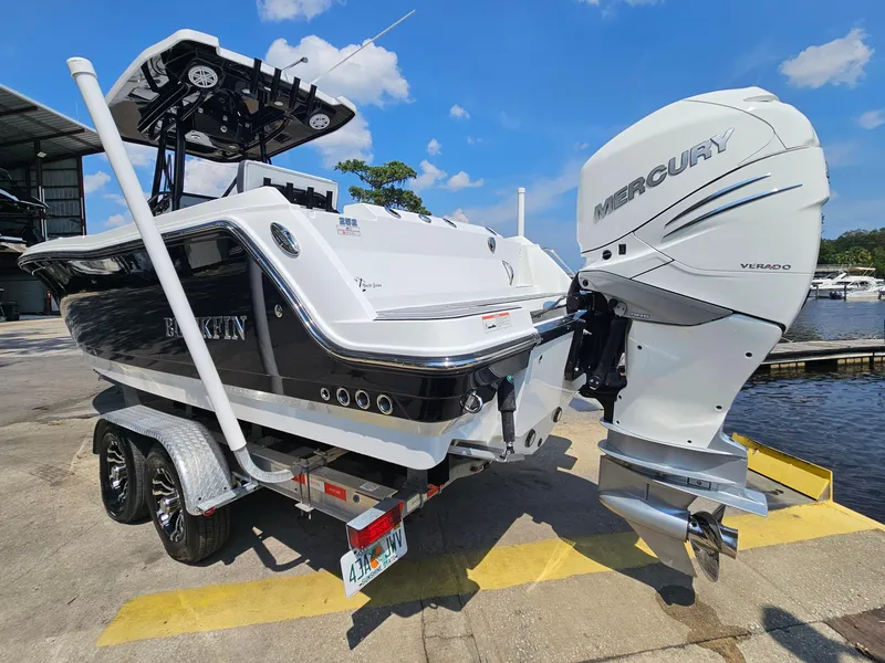 Slide: The Image of 2021 Blackfin 252 CC boat with Mercury engine on a trailer by the water. - 7