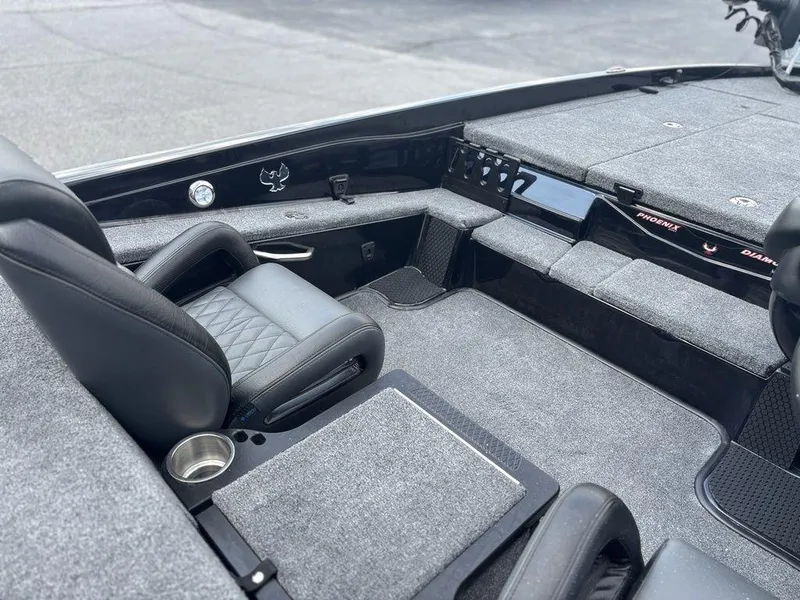 Slide: The Image of Interior of 2026 Phoenix 721 ZXL boat with gray carpet and black seating. - 11