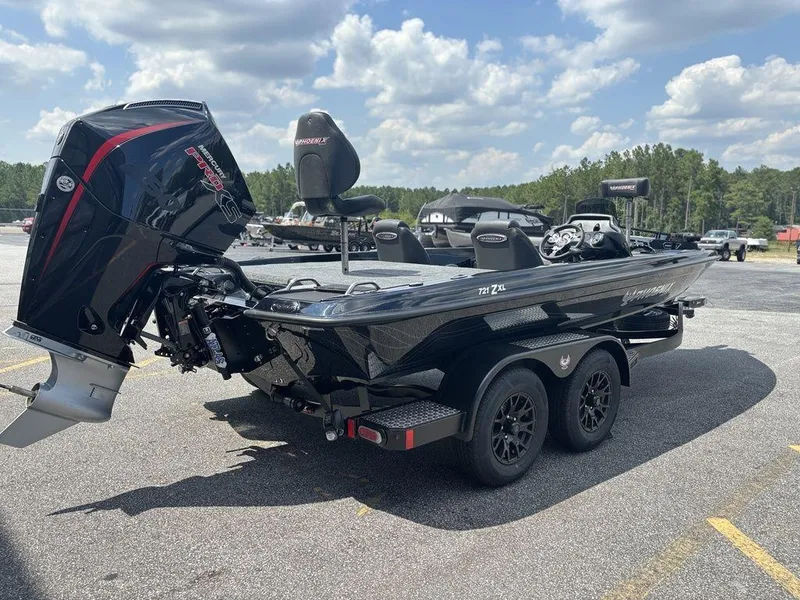 Slide: The Image of 2026 Phoenix 721 ZXL boat with powerful engine, parked outdoors under a cloudy sky. - 9
