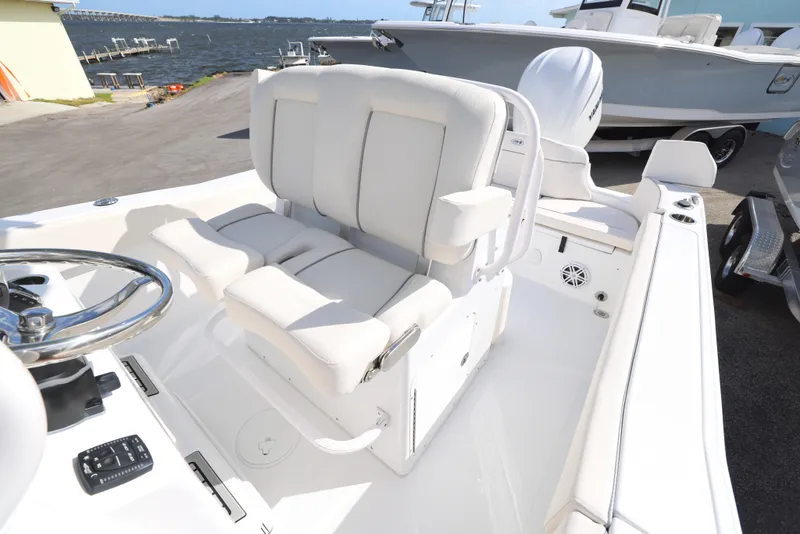 Slide: The Image of 2025 Sea Hunt Ultra 245 SE boat interior with white seating and steering wheel. - 13