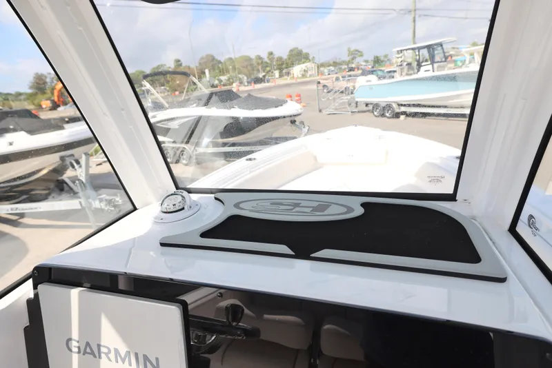 Slide: The Image of 2025 Sea Hunt Ultra 245 SE boat interior with Garmin navigation system. - 15