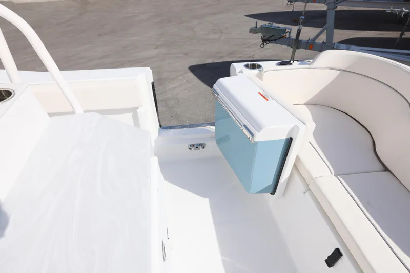 Slide: The Image of 2025 Sea Hunt Ultra 245 SE boat interior with seating and cooler. - 16