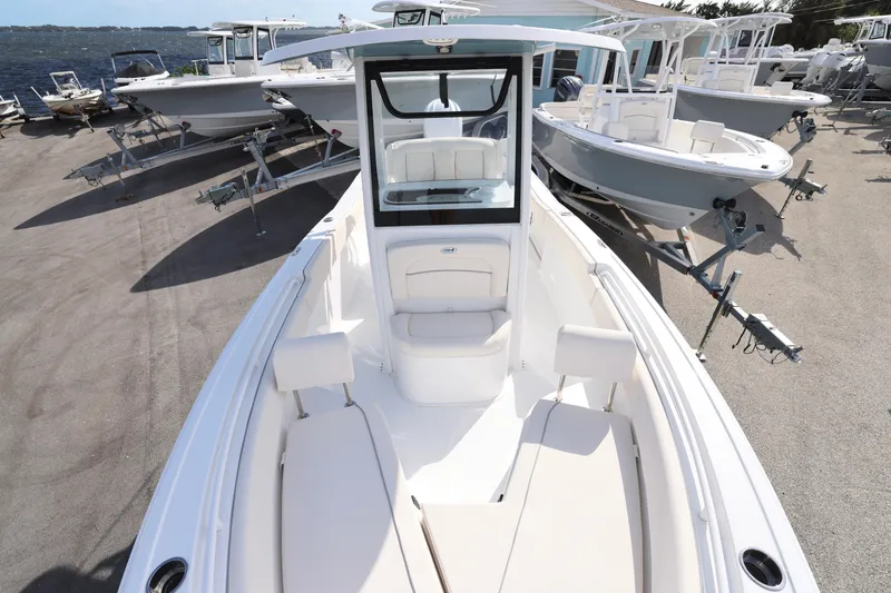 Slide: The Image of 2025 Sea Hunt Ultra 245 SE boat on display at a marina. - 17