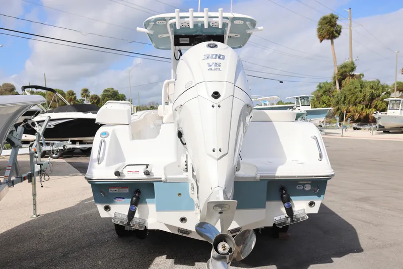 Slide: The Image of 2025 Sea Hunt Ultra 245 SE boat with powerful outboard motor, parked outdoors. - 3