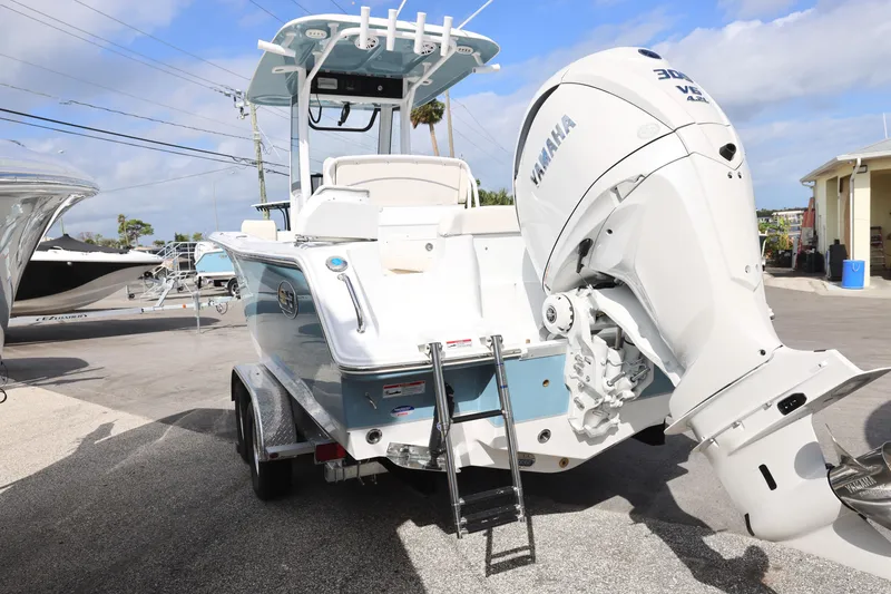 Slide: The Image of 2025 Sea Hunt Ultra 245 SE boat with Yamaha engine, parked on a trailer. - 4