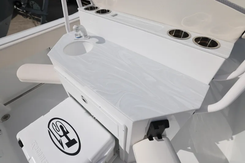 Slide: The Image of 2025 Sea Hunt Ultra 245 SE boat console with cup holders and storage. - 8
