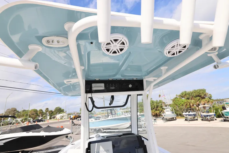 Slide: The Image of 2025 Sea Hunt Ultra 245 SE boat with blue T-top and speakers. - 9