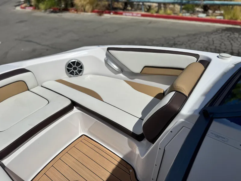 Slide: The Image of 2022 Yamaha Boats AR 195 S interior with cushioned seating and speaker. - 12