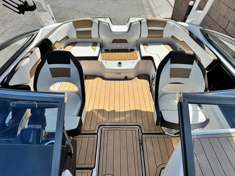 Slide: The Image of 2022 Yamaha Boats AR 195 S interior with stylish seating and wood finish. - 13