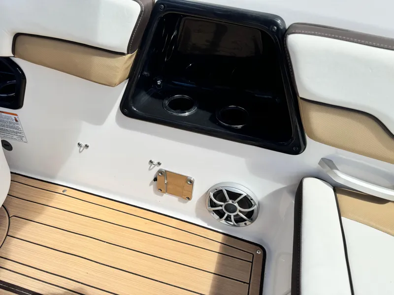 Slide: The Image of Interior of 2022 Yamaha Boats AR 195 S, featuring seating, cup holders, and speaker. - 18