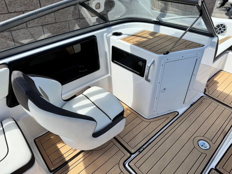 Slide: The Image of 2022 Yamaha Boats AR 195 S interior with sleek seating and wood-style flooring. - 21