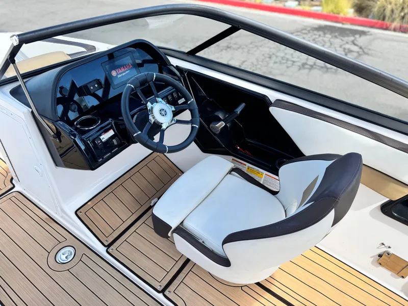 Slide: The Image of 2022 Yamaha Boats AR 195 S cockpit with steering wheel and seating. - 23