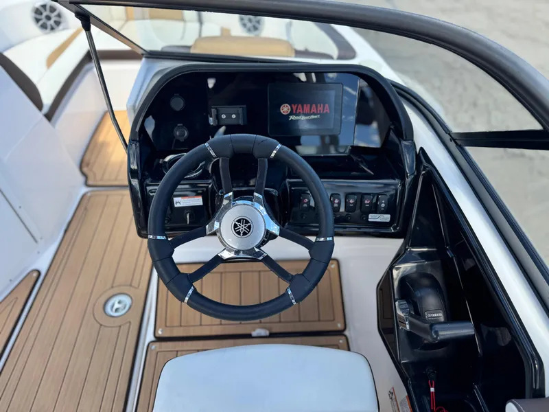 Slide: The Image of 2022 Yamaha Boats AR 195 S dashboard with steering wheel and controls. - 24