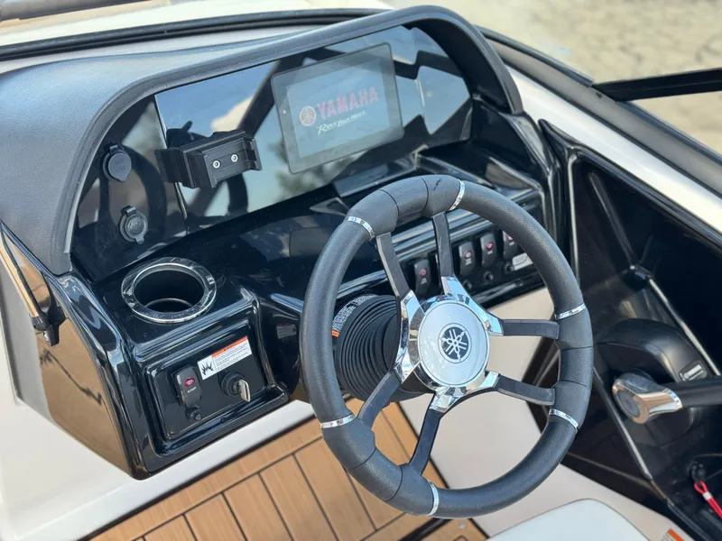 Slide: The Image of 2022 Yamaha Boats AR 195 S dashboard with steering wheel and controls. - 25