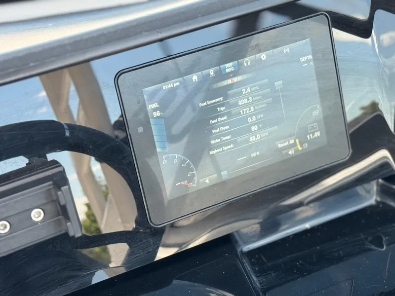 Slide: The Image of Dashboard of 2022 Yamaha Boats AR 195 S showing fuel and trip data. - 28