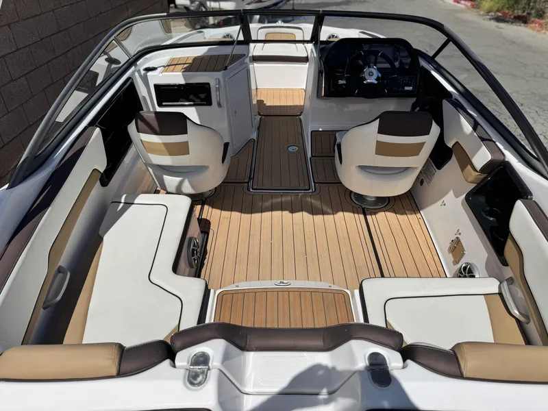 Slide: The Image of 2022 Yamaha Boats AR 195 S interior with sleek seating and modern dashboard design. - 9