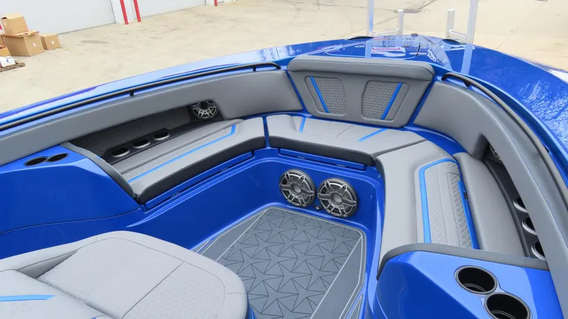 Slide: The Image of Luxurious interior of 2025 MTI 42V boat with blue and gray seating and speakers. - 10