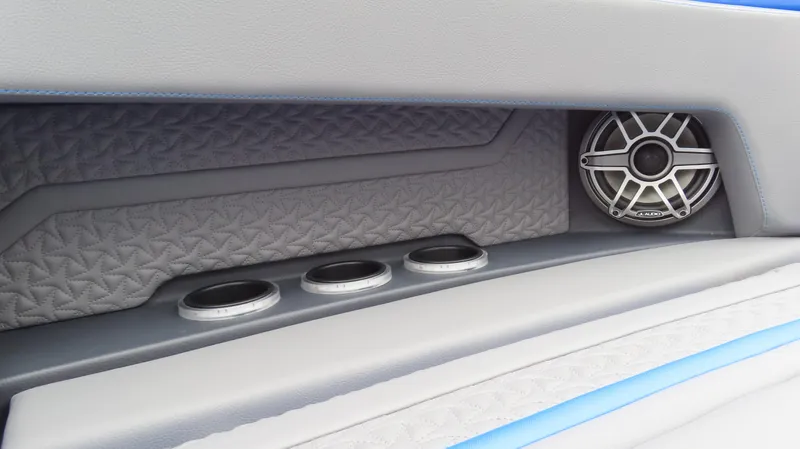 Slide: The Image of Interior of 2025 MTI 42V boat with speaker and cup holders. - 11