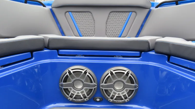 Slide: The Image of Luxury MTI 42V boat interior with blue seating and dual speakers, 2025 model. - 12