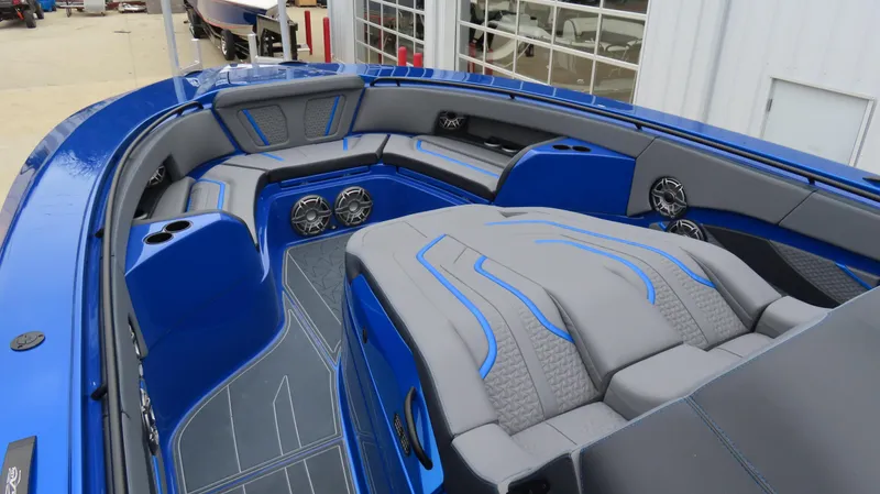 Slide: The Image of 2025 MTI 42V boat interior with blue and gray seating, speakers, and cup holders. - 15