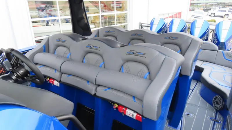 Slide: The Image of Luxury seating on a 2025 MTI 42V boat, featuring blue and gray upholstery. - 23