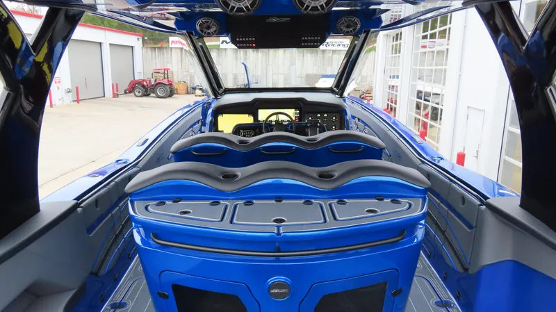 Slide: The Image of Interior view of a 2025 MTI 42V boat, featuring sleek blue design and advanced controls. - 25