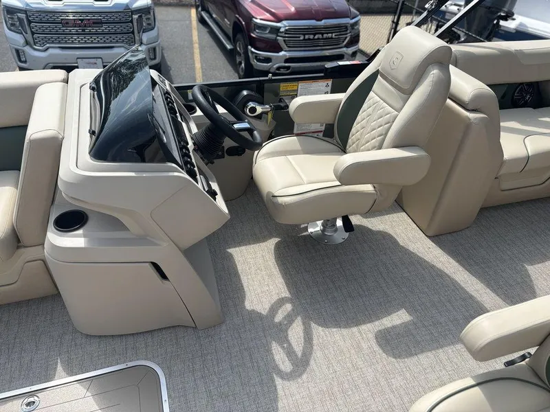 Slide: The Image of 2026 Godfrey SWEETWATER 2286 SB boat interior with captain's chair and steering console. - 11