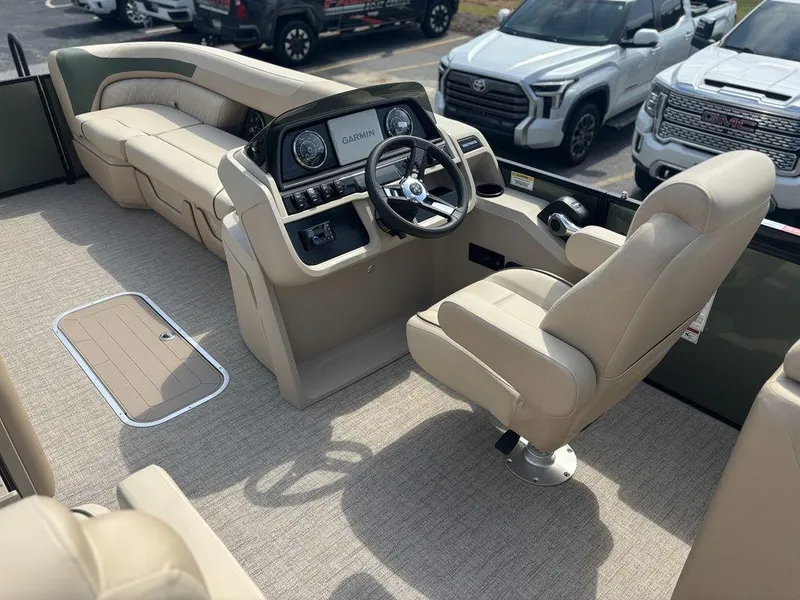 Slide: The Image of 2026 Godfrey SWEETWATER 2286 SB boat interior with beige seating and Garmin dashboard. - 14