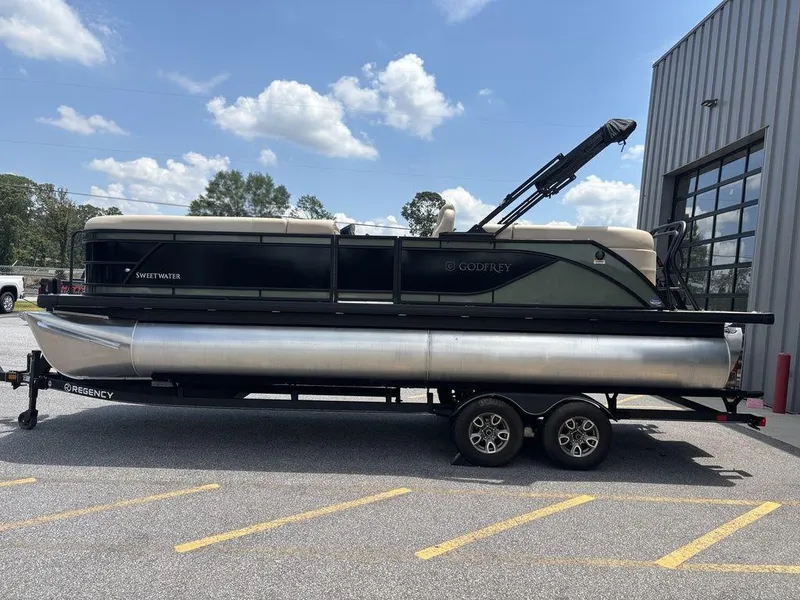 Slide: The Image of 2026 Godfrey SWEETWATER 2286 SB pontoon boat on trailer, parked outdoors. - 4
