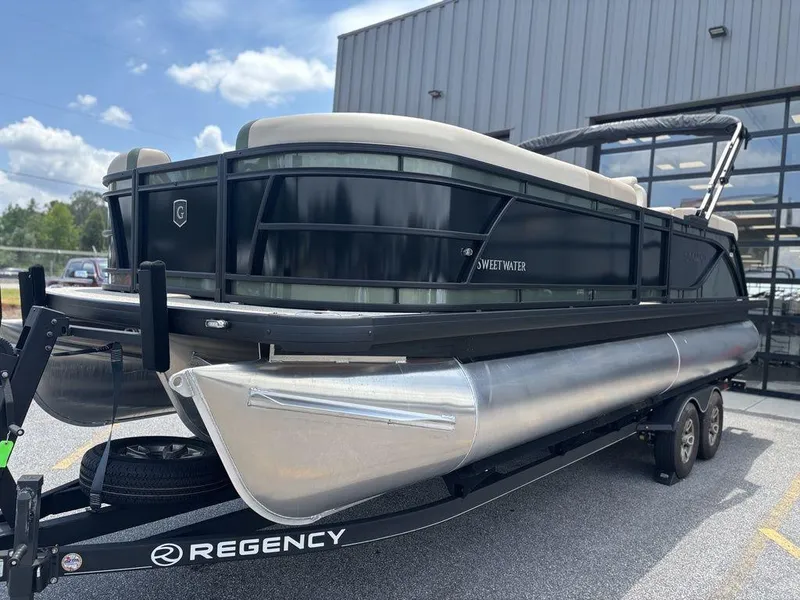 Slide: The Image of 2026 Godfrey SWEETWATER 2286 SB pontoon boat on trailer, parked outdoors. - 5