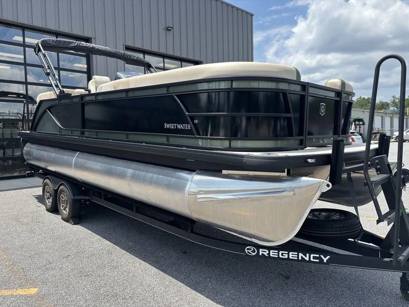Slide: The Image of 2026 Godfrey SWEETWATER 2286 SB pontoon boat on trailer, parked outdoors. - 8