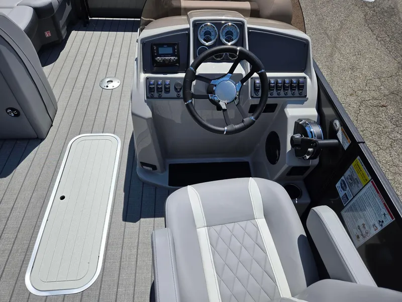 Slide: The Image of Captain's helm of 2026 Starcraft EXS1QDH boat with modern controls and steering wheel. - 10