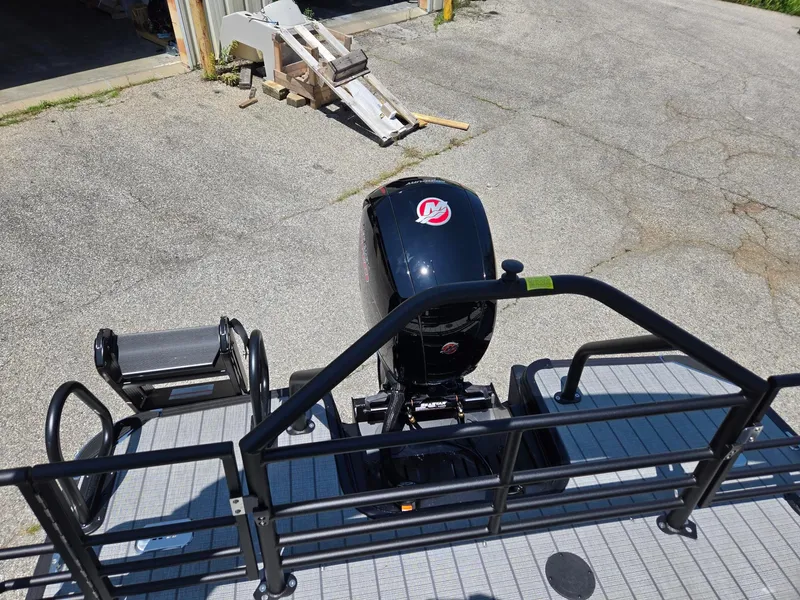 Slide: The Image of 2026 Starcraft EXS1QDH boat with outboard motor, viewed from above on a concrete surface. - 11