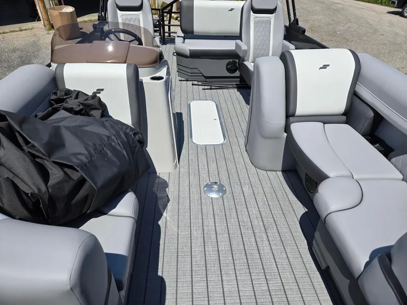 Slide: The Image of 2026 Starcraft EXS1QDH boat interior with gray seating and steering console. - 6