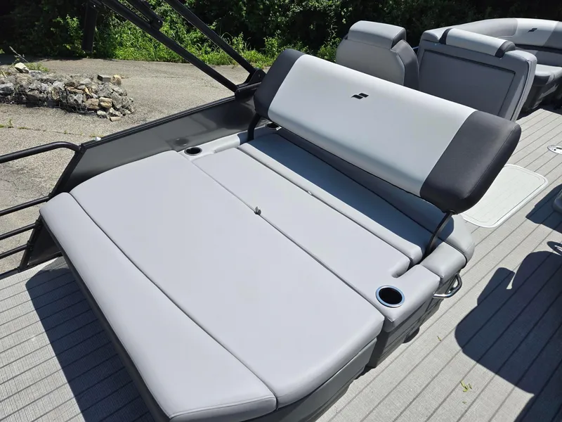 Slide: The Image of Luxurious seating on 2026 Starcraft EXS1QDH boat, featuring sleek gray upholstery and cup holders. - 8