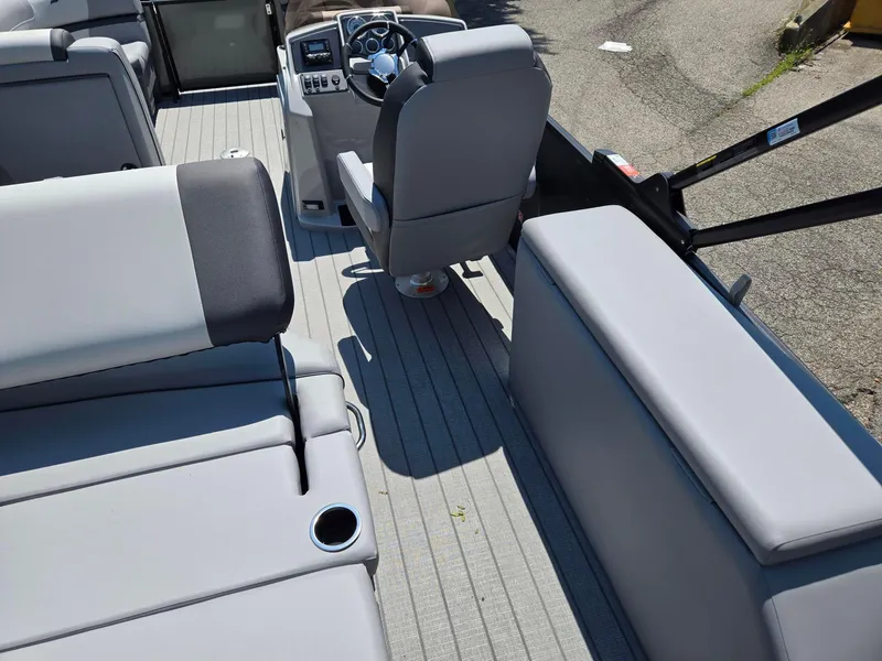 Slide: The Image of Interior of 2026 Starcraft EXS1QDH boat with gray seating and steering console. - 9