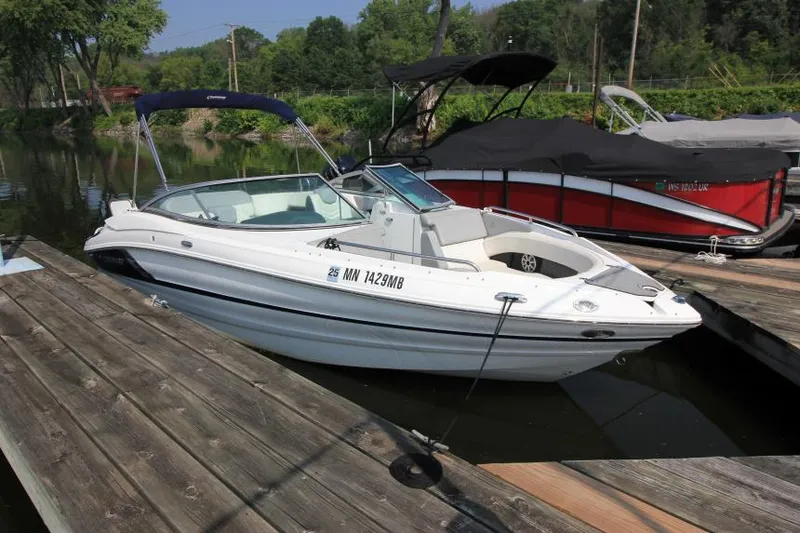 The Image of 2015 Cruisers Sport Series 238 Bow Rider docked on a calm lake. - 1