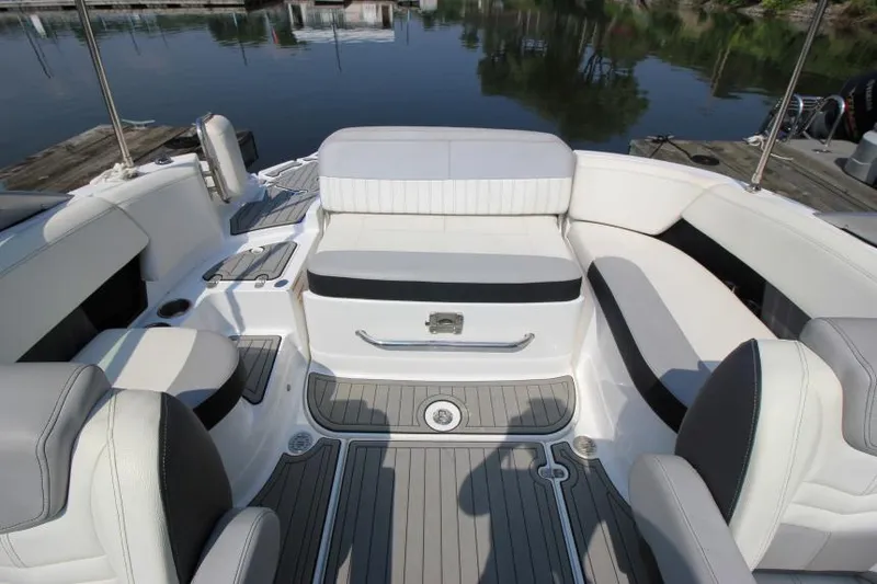 Slide: The Image of 2015 Cruisers Sport Series 238 Bow Rider interior with white seating and gray flooring. - 12