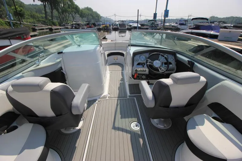 Slide: The Image of 2015 Cruisers Sport Series 238 Bow Rider interior with steering wheel and seating. - 14