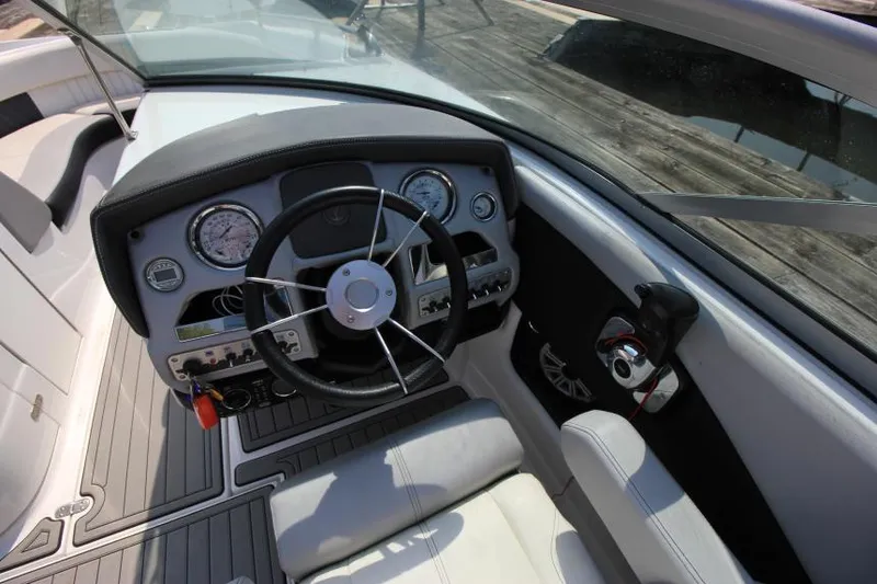 Slide: The Image of 2015 Cruisers Sport Series 238 Bow Rider dashboard with steering wheel and gauges. - 21